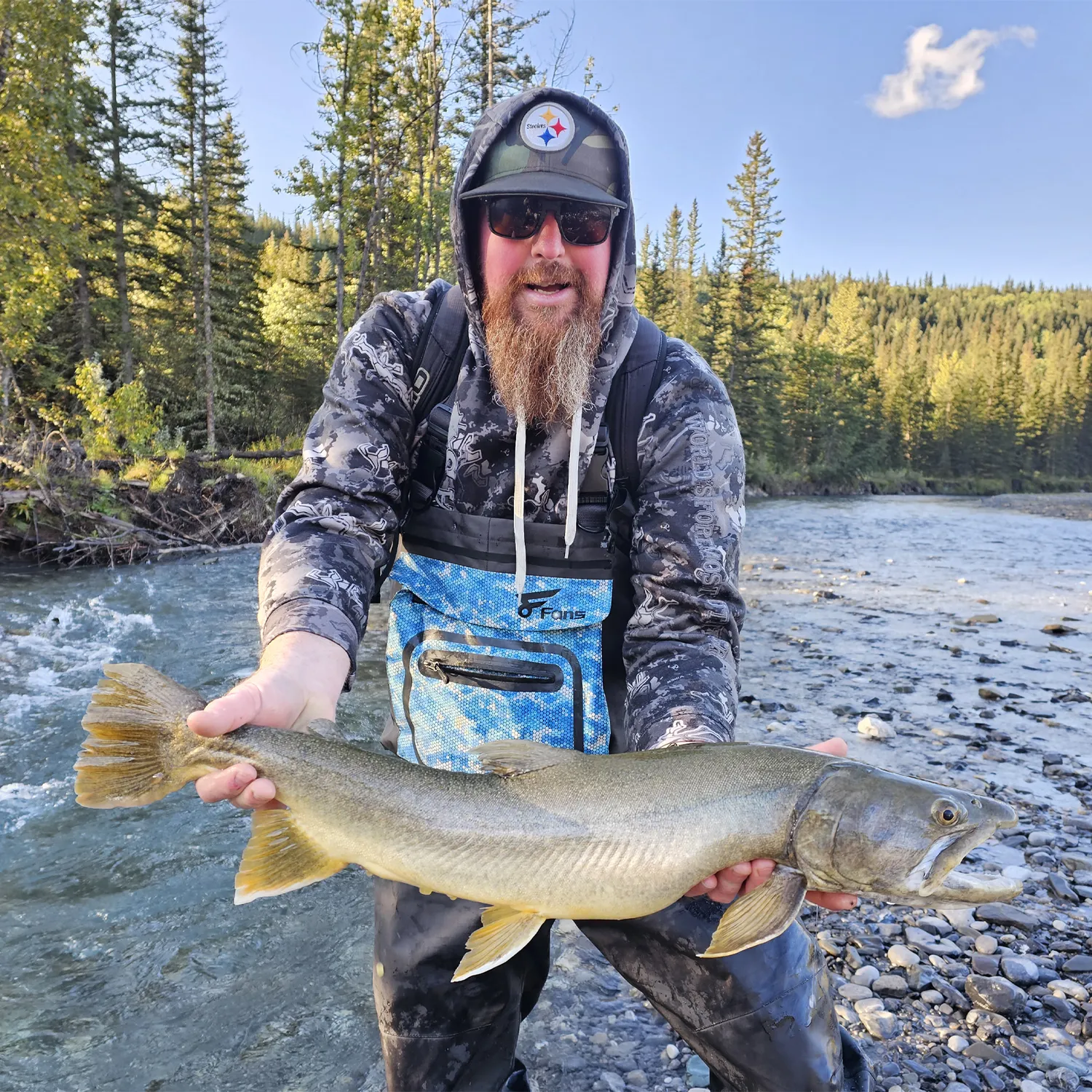 A man was fishing with waering lightweight chest waders
