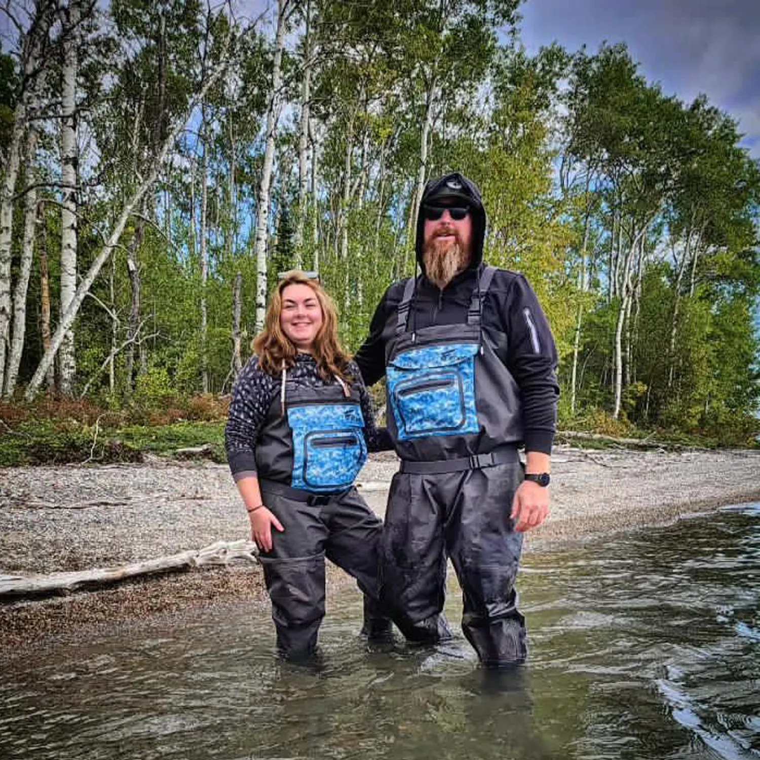 A man and woman were wearing lightweight waterproof chest waders
