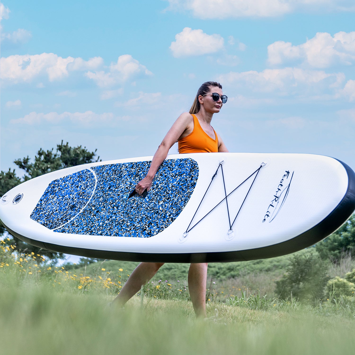 A woman was carrying Feath-r-lite blow up paddle board camouflage 10' deep blue color