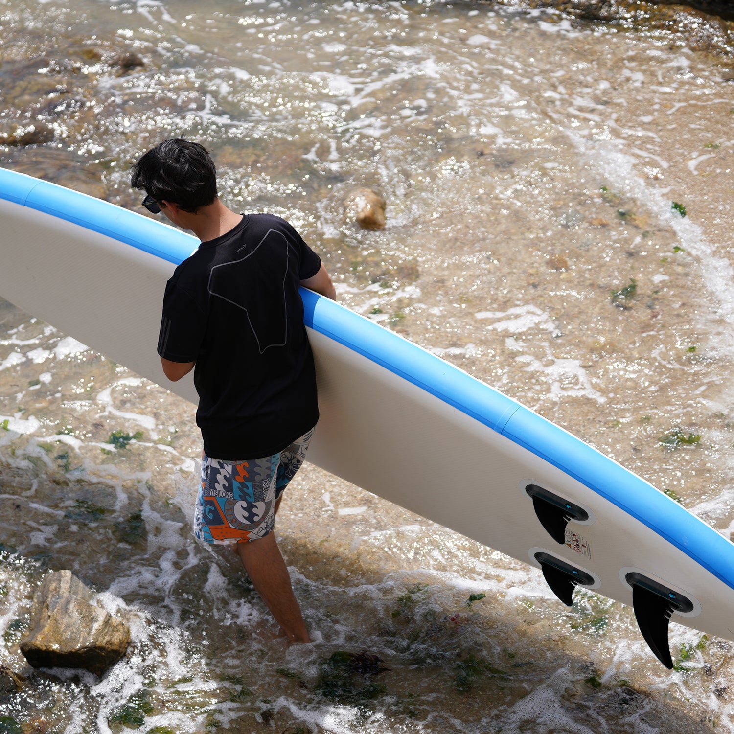 A man was carrying an inflatable paddle board