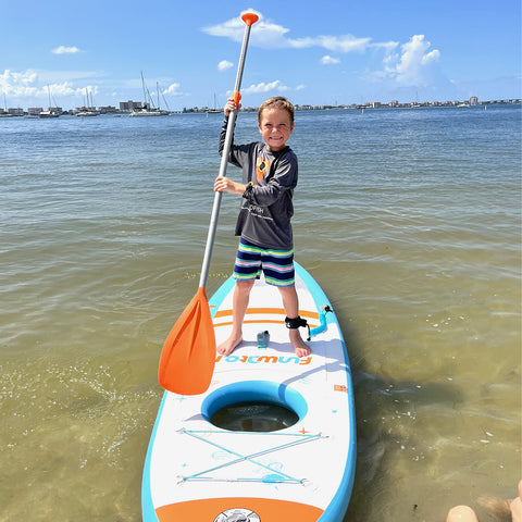 A boy is playing paddle board