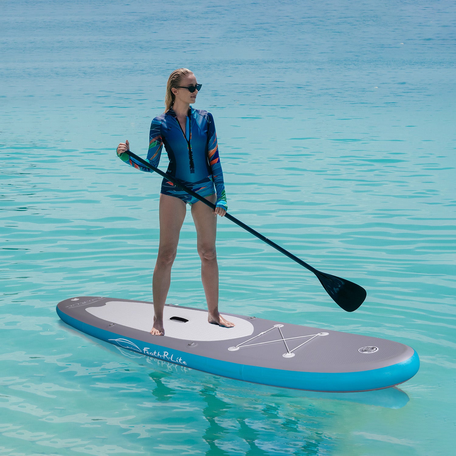 A woman was paddling on Feath-r-lite Feather 11' paddle board inflatable