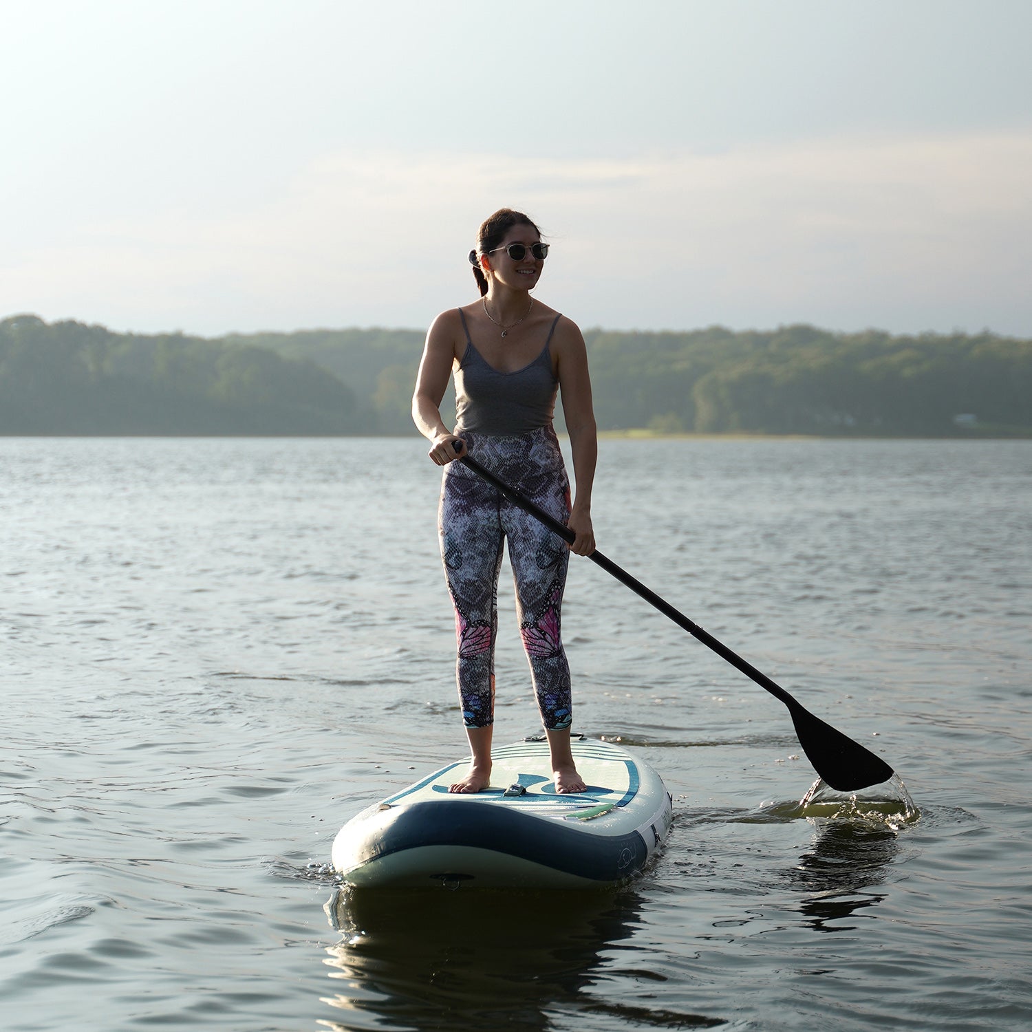 A women is paddleboarding with FUNWATER SEA TURTLE SUP