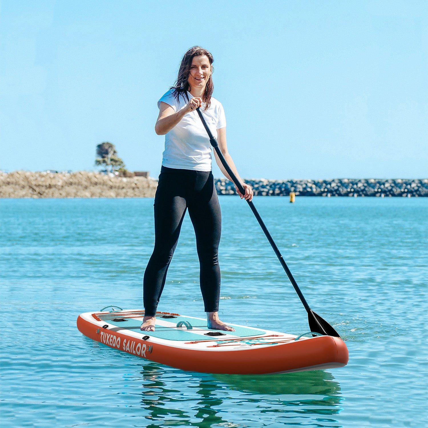 A woman was standing on Tuxedo Sailor fishing paddle board and paddleboarding